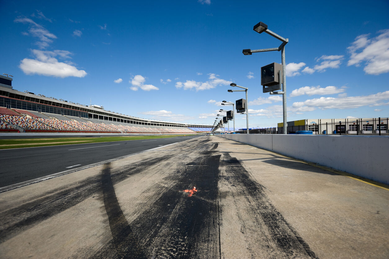 Low angle view of pit row at a Stock car race track.