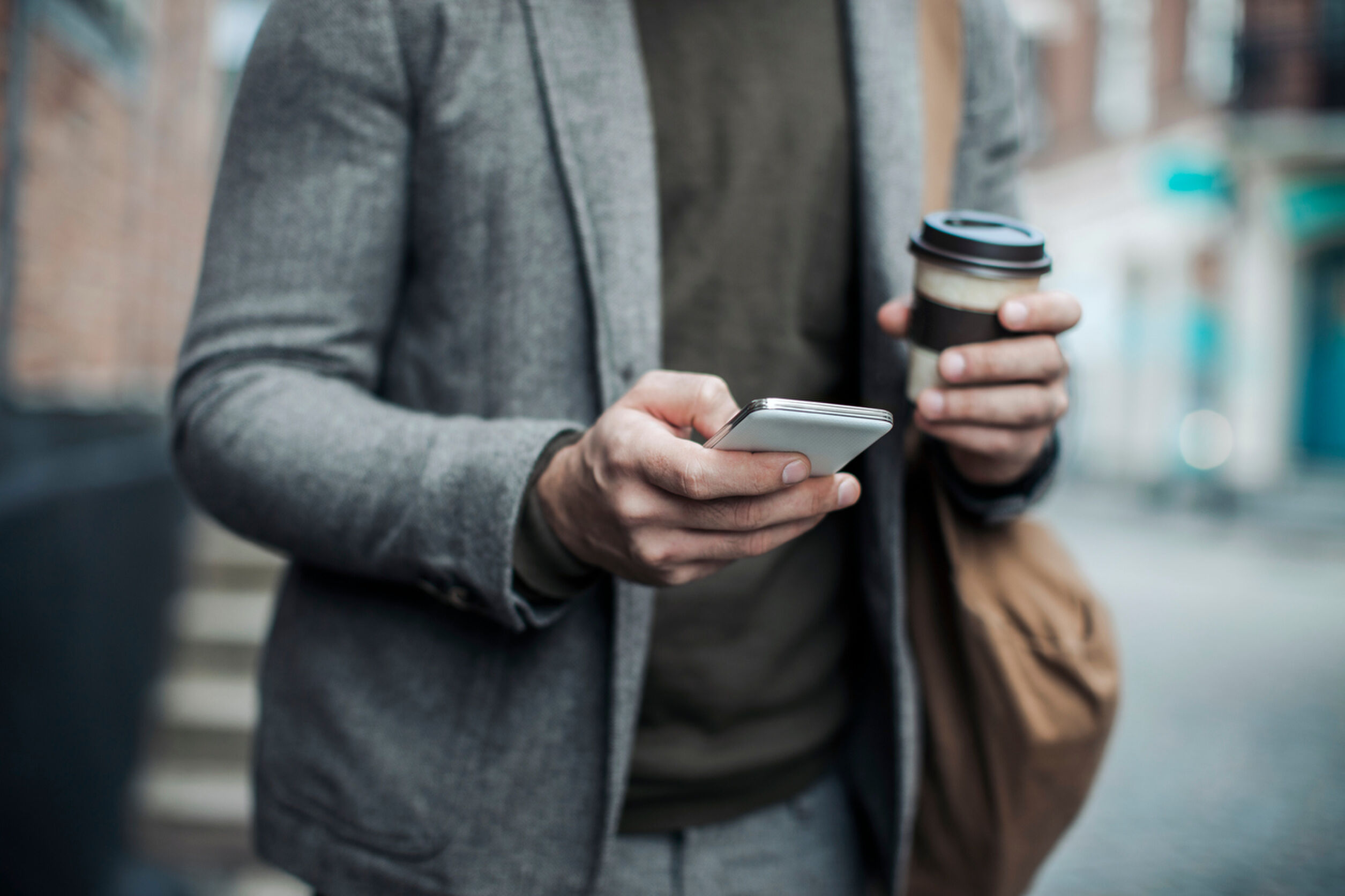 Photo of a businessman using mobile phone in the city