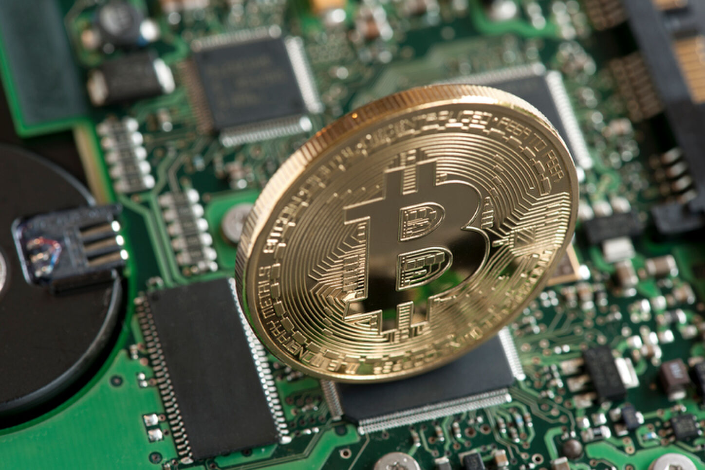 Sao Paulo, Brazil - February 04, 2015: Bitcoin symbol, studio shot with circuit board background.