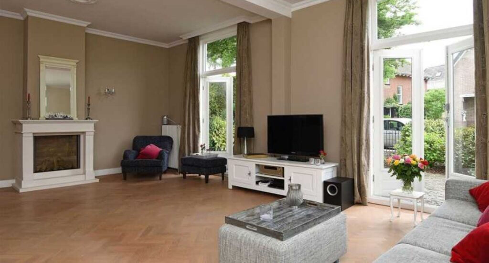 De living met openslaande deuren naar de tuin.