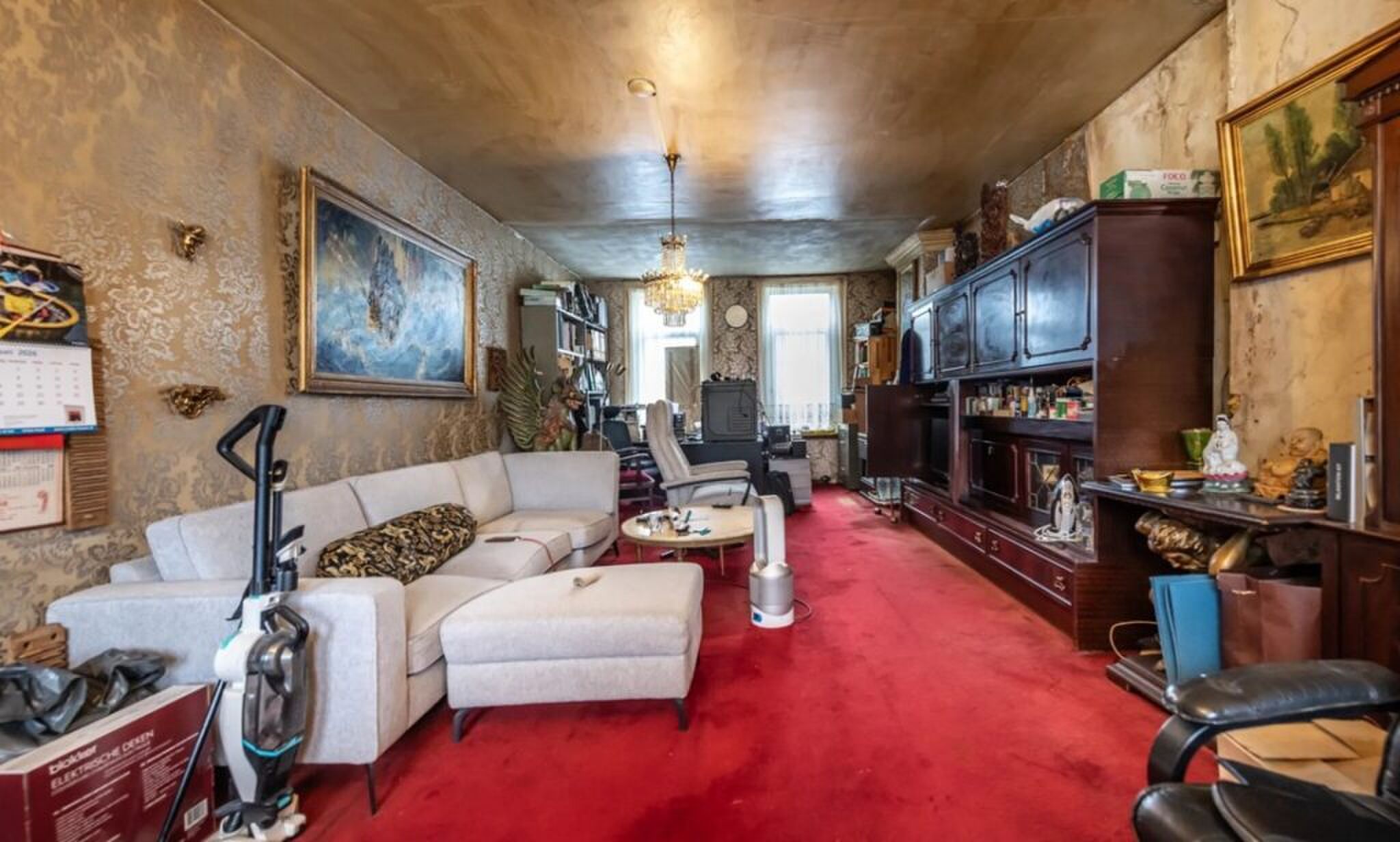 De oude woonkamer met lelijke aankleding.