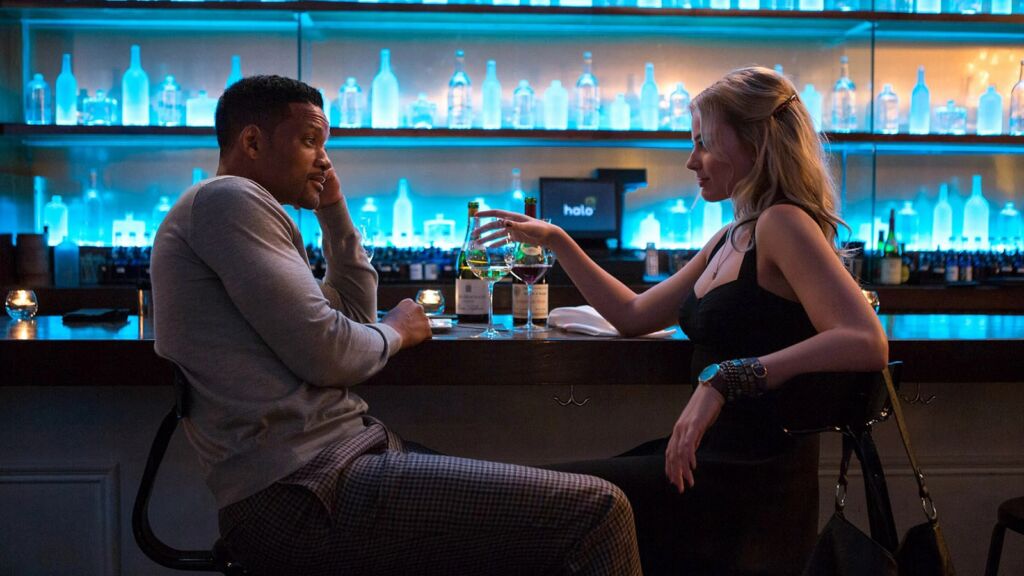 Een man en vrouw die samen aan een bar zitten. 