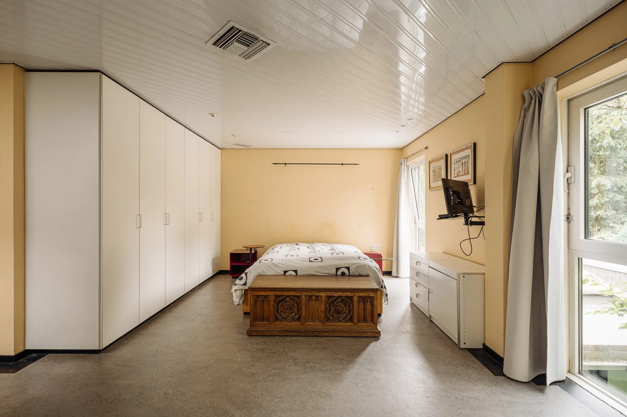 Een slaapkamer met tweepersoonsbed en televisie.