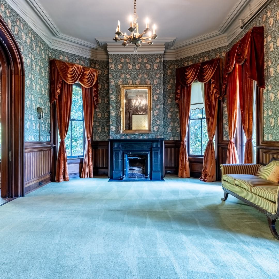 Een kamer met open haard en bank in het Creel House