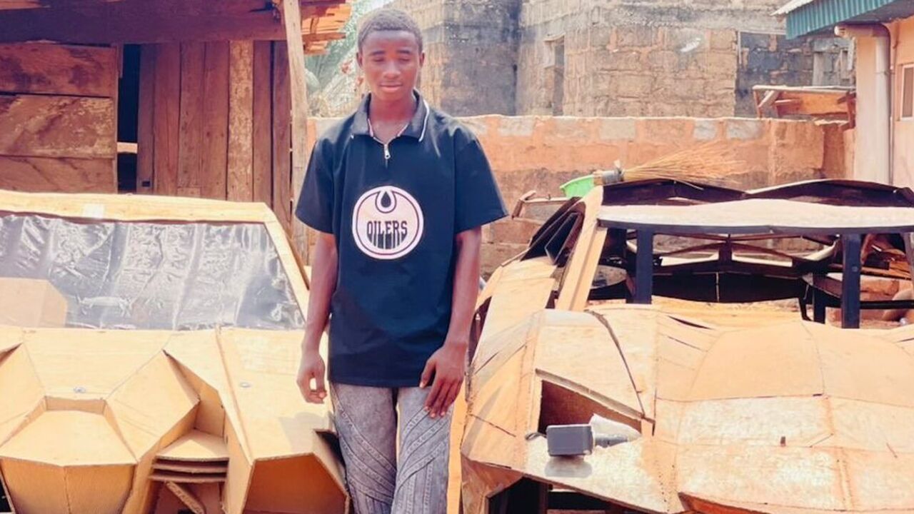 De Nigeriaanse jongen, naast zijn Lamborghini van karton