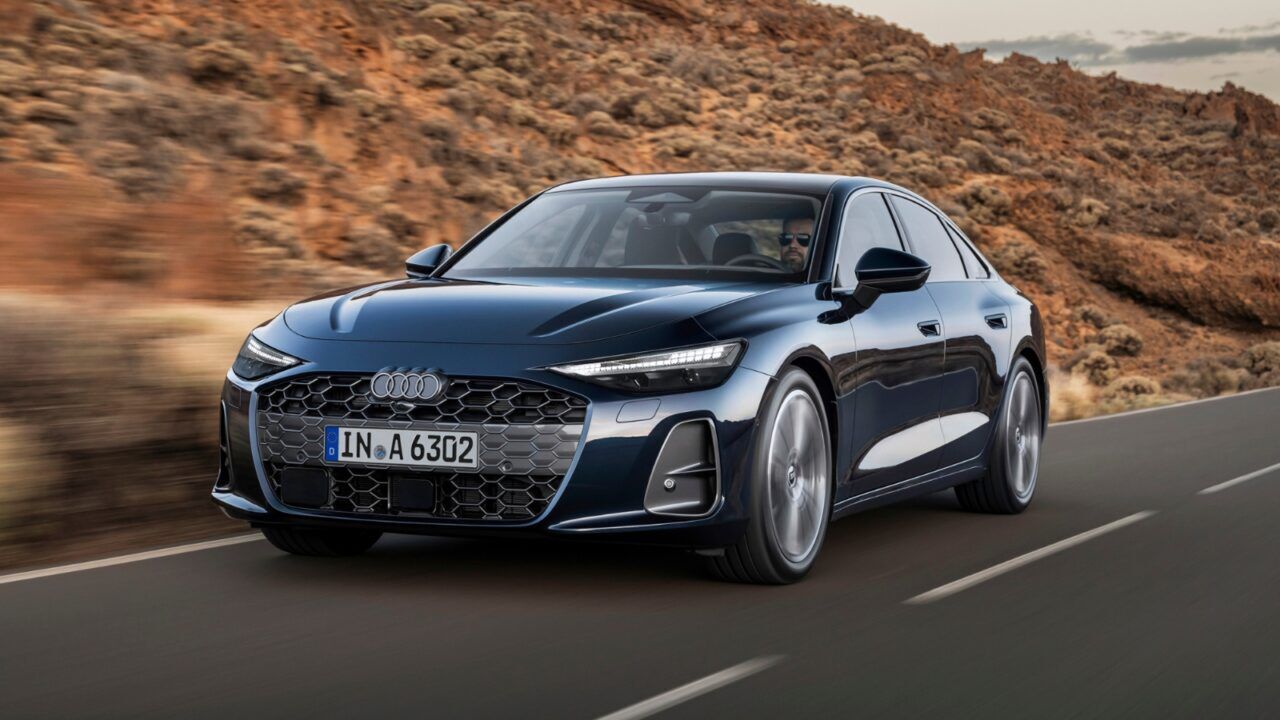 De nieuwe Audi A6 Limousine rijdend op een weg in rustiek gebied