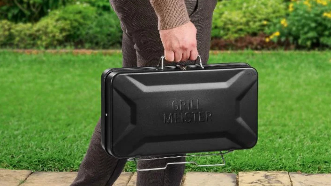 een man houdt de Lidl BBQ koffer vast