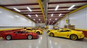 Een garage vol met nieuwe en oude Ferrari-wagens