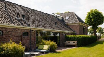 De buitenzijde van de woonboerderij aan de Amstel.