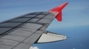 Een vleugel van een vliegtuig in de lucht