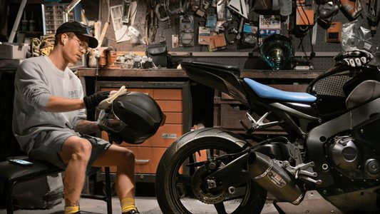 Een man die aan het sleutelen is aan zijn motor