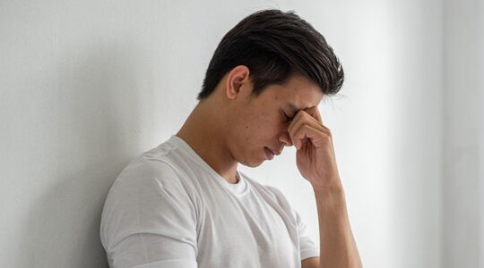 Een man die in zijn ogen wrijft